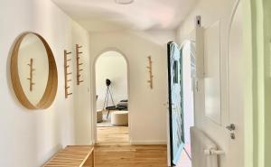 a hallway with arches and a mirror on the wall at Bungalow in Rottachs Bestlage in Rottach-Egern
