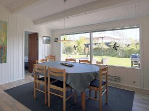 a dining room with a table and chairs and a window at 6 person holiday home in Gedser in Gedser