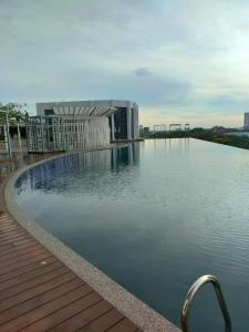 a swimming pool on top of a building with water at Prestige Troika Kota Bharu in Kota Bharu