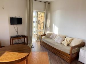 a living room with a couch and a table at Charming apartment with sea view in Armação de Pêra - 70 m² in Armação de Pêra