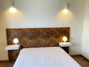 a bedroom with a bed with two lights on it at Charming apartment with sea view in Armação de Pêra - 70 m² in Armação de Pêra +36 photos