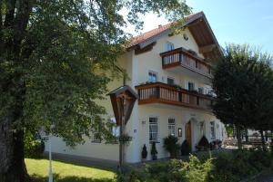 a large white building with a balcony on it at Servus Gelting in Geretsried