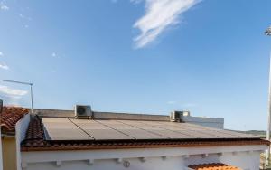 a tile roof on top of a white building at San Simplicio eco-apartment in Olbia