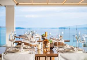 a table with white table cloths and wine glasses at Ammoa Luxury Hotel & Spa Resort in Nikiti