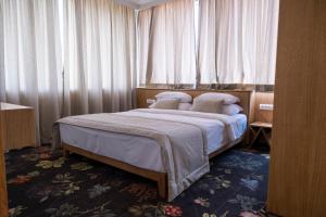 Lova arba lovos apgyvendinimo įstaigoje Hotel Opal Home