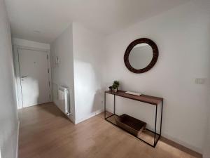 a room with a table and a mirror on a wall at BPIRINEOS-Pico Cerler in Benasque