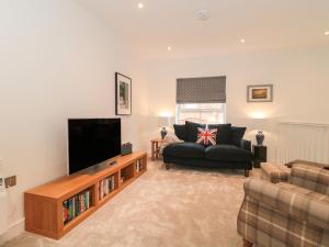 a living room with a flat screen tv and a couch at Flat 2 in Bournemouth