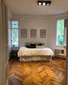 a bedroom with a bed and a wooden floor at MARY in Buenos Aires