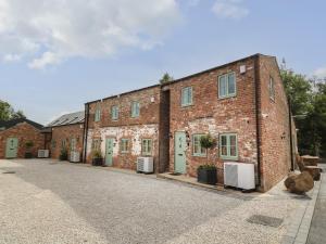 a brick building with green doors on a street at The Willow in Selby