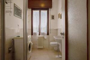 a bathroom with a toilet and a sink at Villa Carolina in San Felice del Benaco +19 photos