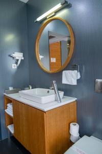 a bathroom with a sink and a mirror at Hotel Opal Home in Sarajevo