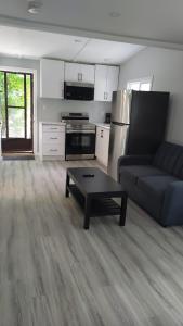 a living room with a couch and a coffee table at Wasaga Beach Cottage 2 in Wasaga Beach