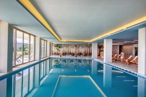 a swimming pool in a hotel room with a view at Ammoa Luxury Hotel & Spa Resort in Nikiti