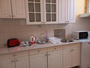 A kitchen or kitchenette at Szent István Apartman