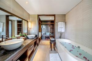 a bathroom with two sinks and a bath tub at RiverTown Hoi An Resort & Spa - formerly Ann Retreat Resort & Spa in Hoi An
