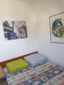 a bed with two pillows on it in a room at Chez Christine in Ploemel