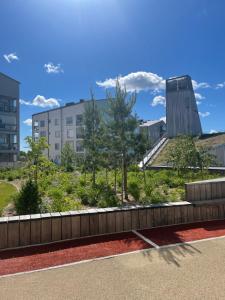 a view of a park with trees and buildings at The Seaside Apartment in Turku