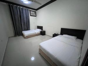 Кровать или кровати в номере Salalah-Al Shwamekh Suites