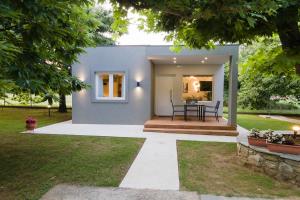 a home with a pathway leading to the front yard at Elena luxury living in Paralía Skotínis