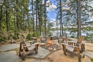 a group of chairs around a camp fire at Lakefront Cottage Boat Dock, Patio and Kayaks! in Oxford +23 photos