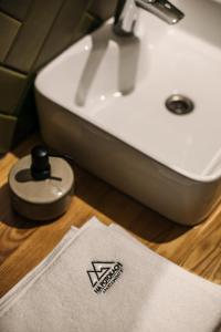 a bathroom with a sink and a white towel at Apartamenty Na Potokach in Żegocina +53 photos
