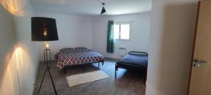 a bedroom with a bed and a lamp and a window at Maison Pré Long et Pré Long House in Le Thoronet +28 photos