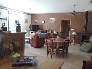 a living room with a table and a dining room at Villa Roland en Bourgogne in Chagny