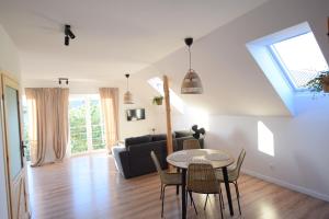 a living room with a table and a couch at Johnny House 2 in Suwałki