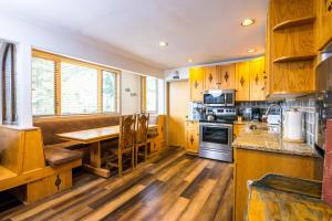 a kitchen with wooden cabinets and a wooden table at Tamarak 36 in Snowmass Village