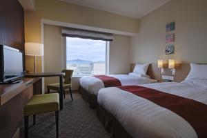 Postel nebo postele na pokoji v ubytování Miyako Hotel Yokkaichi