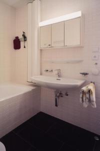 a white bathroom with a sink and a tub at Apartment Familie Kinz im Haus Zalim in Brand