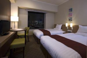 Postel nebo postele na pokoji v ubytování Miyako Hotel Yokkaichi
