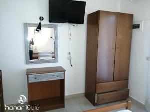 a living room with a mirror and a dresser at Avra Ηouse in Kriopigi
