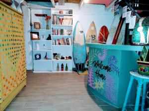 a room with a surfboard on a shelf at Casajungla Hostel in Jacó +79 photos