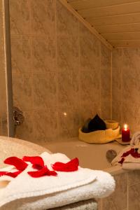 Aigelsbach的住宿－Landgasthof Kammerhof，浴室配有带蜡烛和毛巾的浴缸。