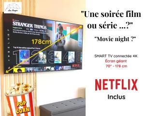 une télévision avec un pop-corn sur un mur dans l'établissement L'Eden - 2 chambres - Centre ville - ASCENSEUR, à Arras