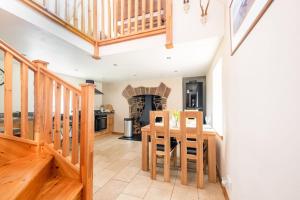 a dining room and kitchen with a table and chairs at Cosy & rustic retreat - Woodland Cottage. in Nairn