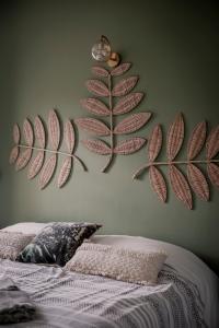 a bedroom with two large leaves on the wall at Les Hauts de Diane, CUERS var in Cuers +19 photos