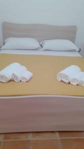 two towels are sitting on a bed at Da Nonno Presta in Buonvicino
