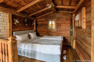 a bedroom with a bed in a wooden cabin at HIP Hotel in Heidelberg