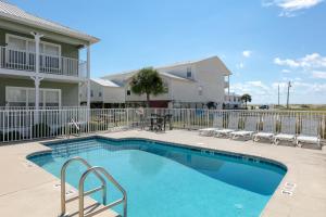 a swimming pool in front of a house at Three C's 202 in Gulf Shores