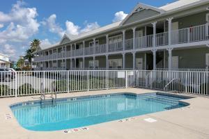a building with a swimming pool in front of a building at Three C's 202 in Gulf Shores