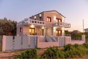 a large white house with a large deck at Athens Villa Artemis pool Sea Airport in Artemida