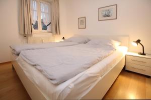 a bedroom with two beds and a lamp on a night stand at Doerpstraat 9_ Whg_ 1 in Wyk auf Föhr +12 photos
