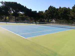 a tennis court with two tennis courts at Victory Village 10C in Quinta do Lago