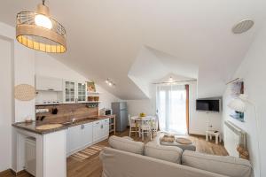 a living room with a couch and a kitchen at Guest house DaLi in Rovinj