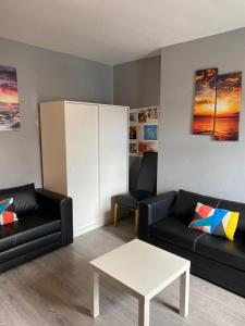 a living room with two black couches and a table at Super Central Dublin Apartments in Dublin