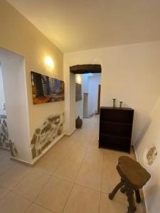 a hallway with a table and a bench in a room at Koundouros Home in AmigdhalokeFálion