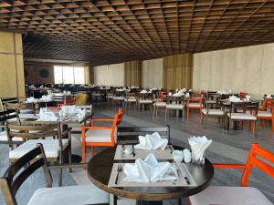 a dining room with tables and chairs and tablesktop at Apec Mandala Phú Yên Hương Giang Condotel in Liên Trì (3)