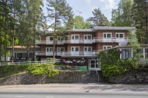 a large brick house with stairs leading up to it at Hotelli-Ravintola Gasthaus Lohja in Lohja